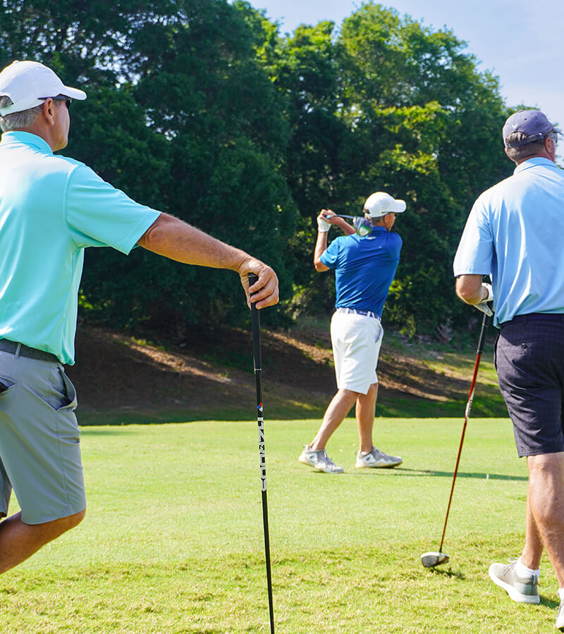3 golfers on course